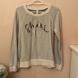 Grey sweater that has not been used, but has been sitting in the closet a while.